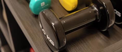 A set of dumbbells on a rack.