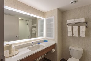 A bathroom with a large mirror, a sink, a toilet, and a towel rack. - Holiday Inn Express & Suites Belleville by IHG (Belleville)
