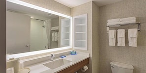 A bathroom with a large mirror, a sink, a toilet, and a towel rack. - Holiday Inn Express & Suites Belleville by IHG (Belleville)