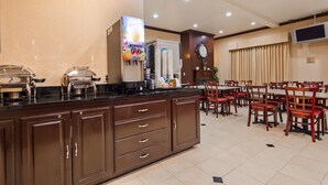A hotel lobby with a buffet area, a clock, and a television. - Best Western Route 66 Glendora Inn (Glendora)