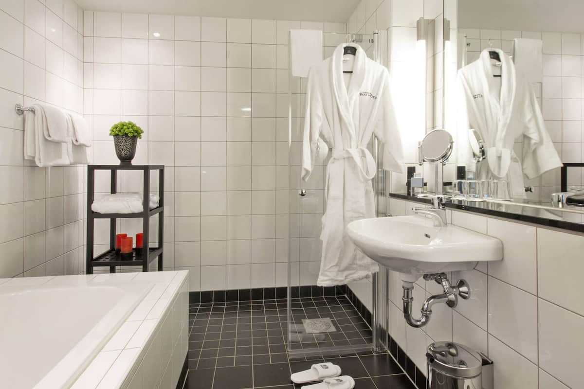 junior suite, 1 king bed, non smoking, terrace | bathroom | free toiletries, hair dryer, heated floors, towels