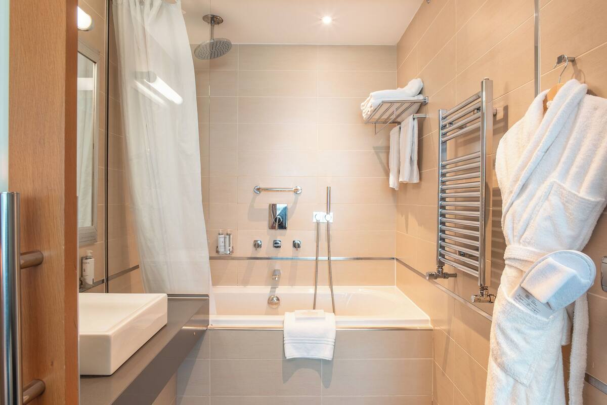 superior double room | bathroom | bathtub, free toiletries, hair dryer, bathrobes