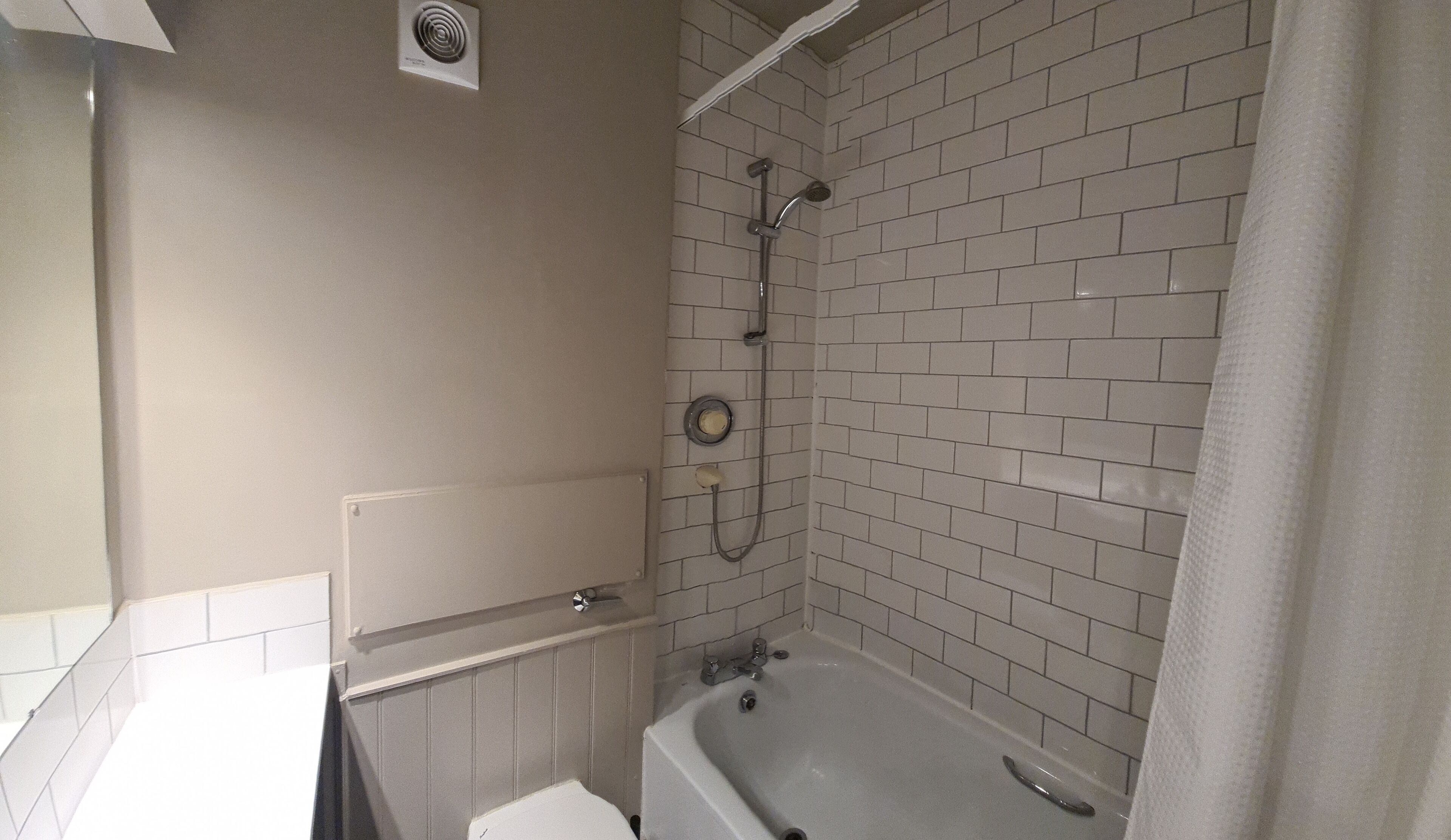 A bathroom with a bathtub, a shower, and a toilet.