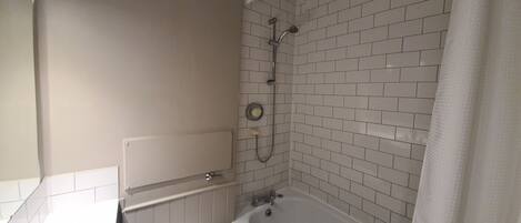 A bathroom with a bathtub, a shower, and a toilet.