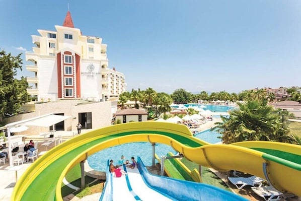 A hotel with a water park, including a pool and a water slide.