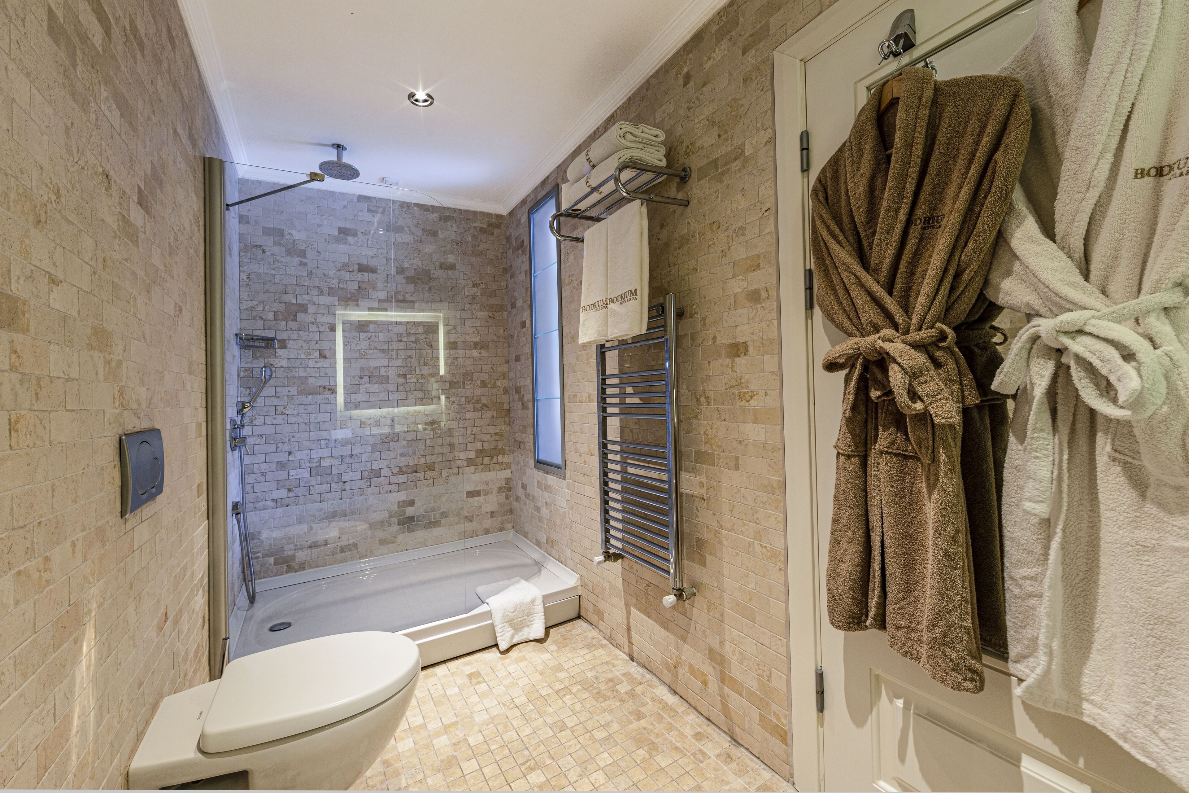 luxury suite | bathroom | designer toiletries, hair dryer, bathrobes, slippers
