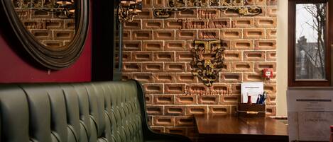 A brick wall with a sign reading "The Temperance Inn" and a wooden table with a menu.