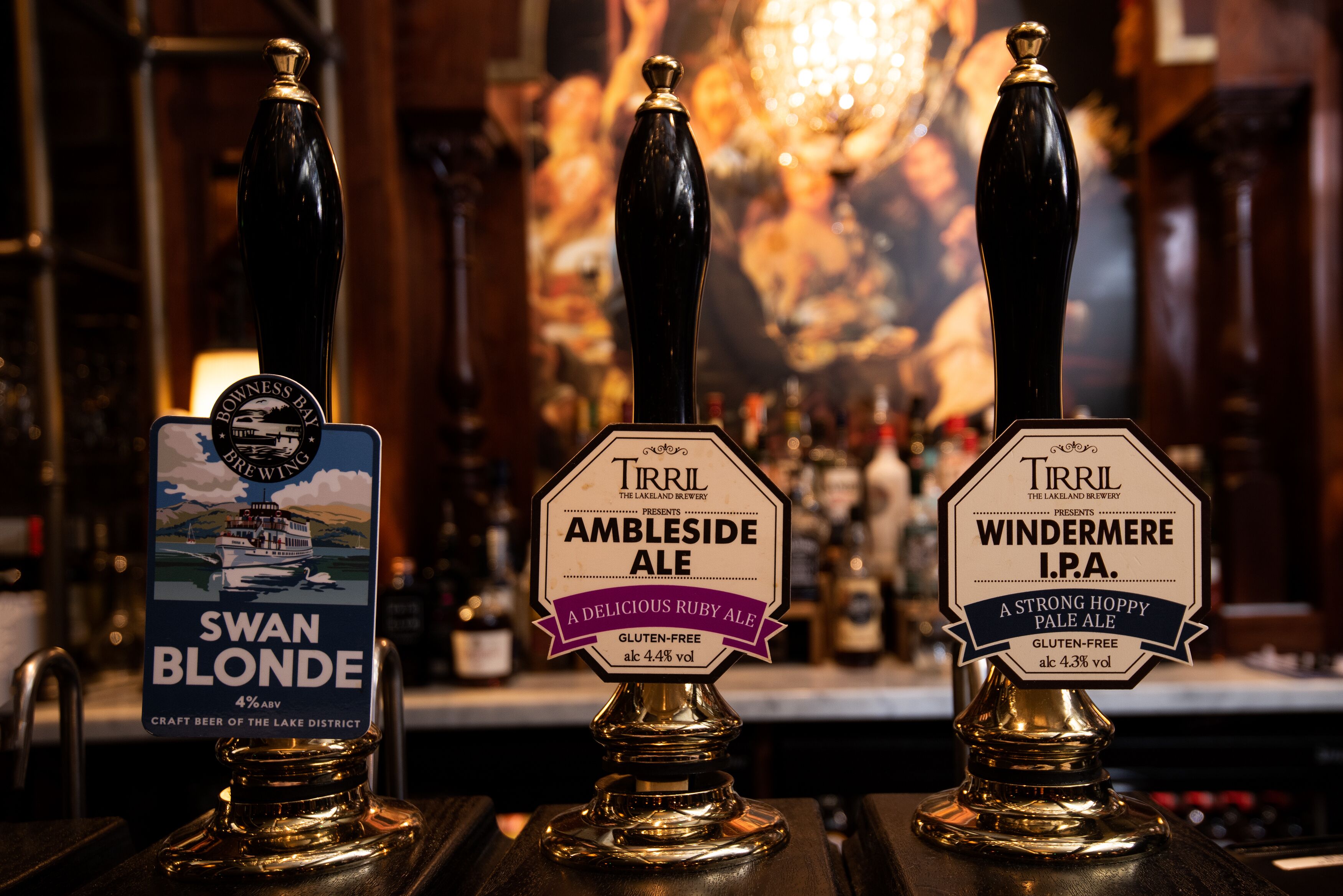Three beer taps labeled with different beer names and types.
