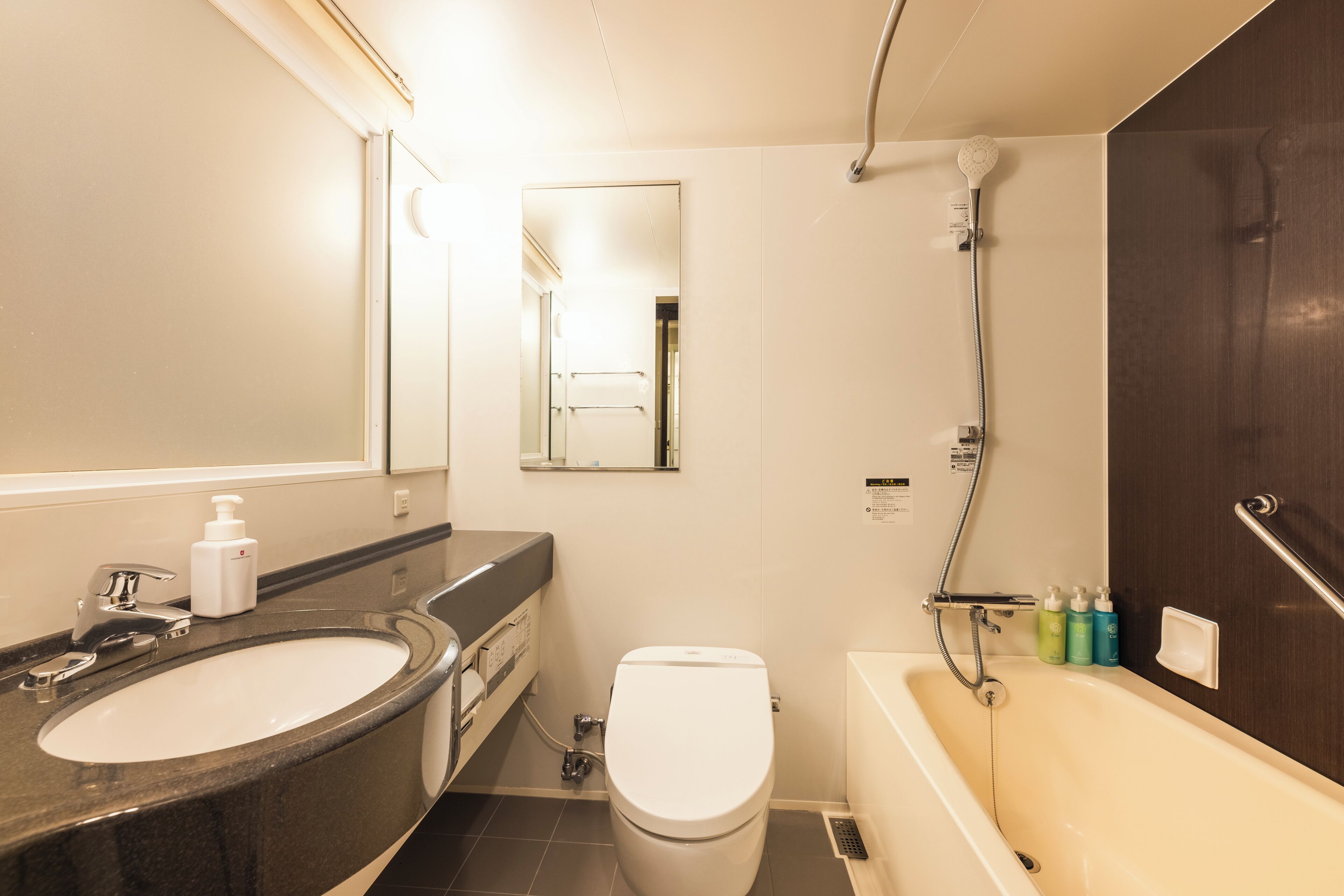 A bathroom with a sink, toilet, and bathtub.
