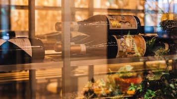 A glass display case with bottles of wine, including a bottle labeled "Barolo."