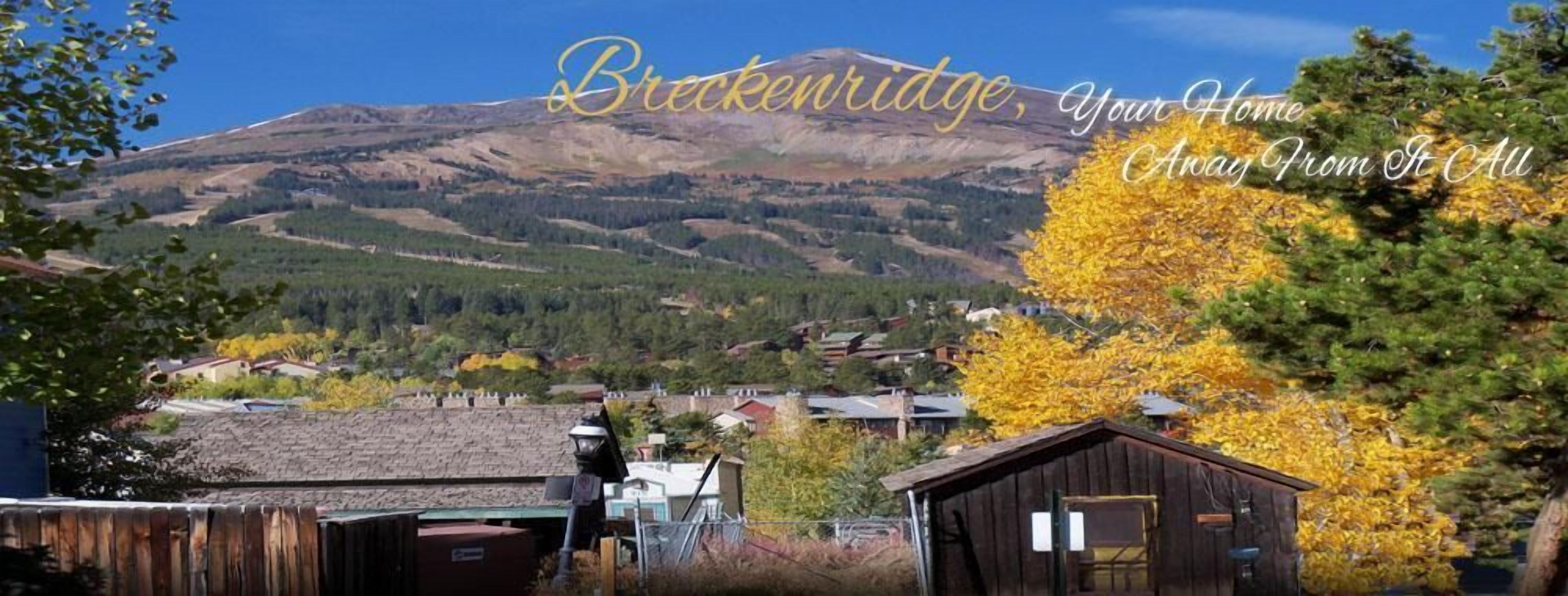 A mountain view with a town in the foreground, a wooden cabin, and a sign that reads "Brecknridge, Your Home Away From It All".