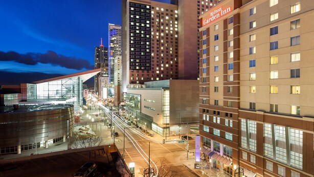 A hotel with a modern design, featuring a prominent glass facade and a rooftop terrace. - Hilton Garden Inn Denver Downtown (Denver)