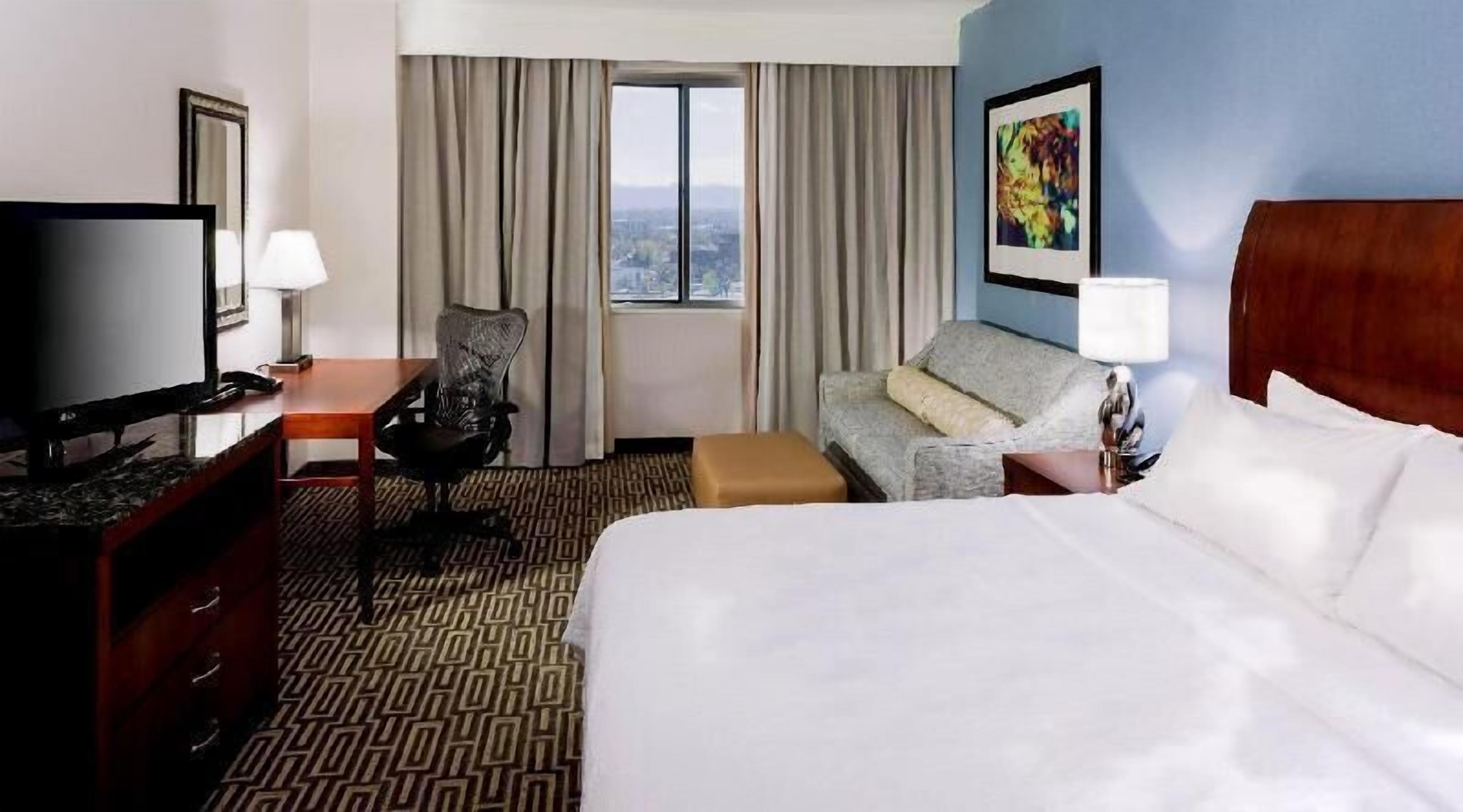 Premium bedding, desk, laptop workspace, iron/ironing board