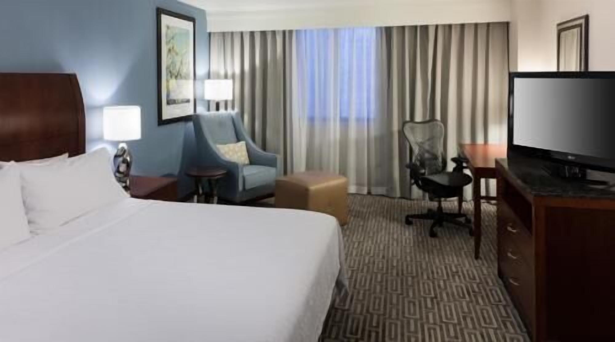 Premium bedding, desk, laptop workspace, iron/ironing board