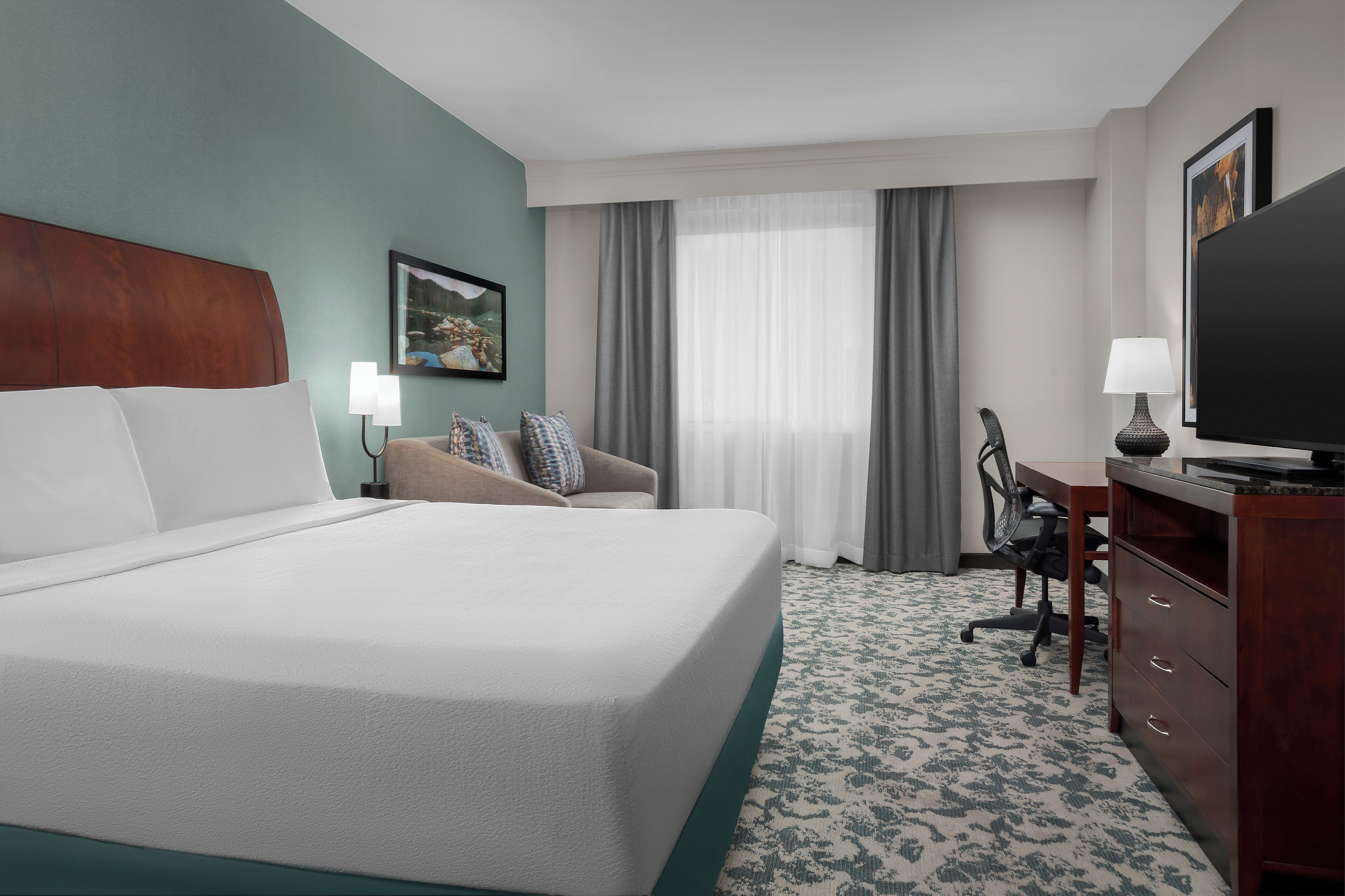 Premium bedding, desk, laptop workspace, iron/ironing board