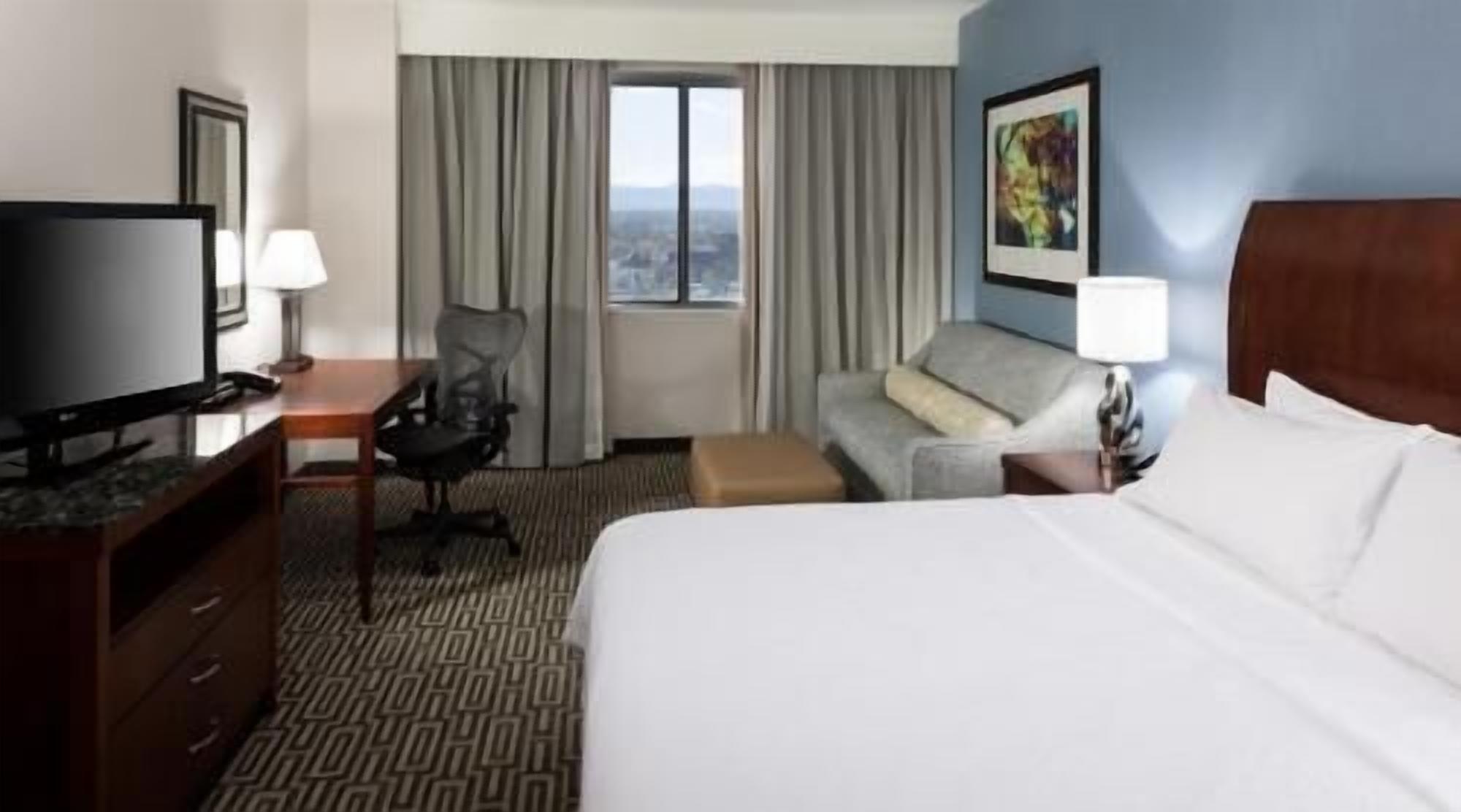Premium bedding, desk, laptop workspace, iron/ironing board