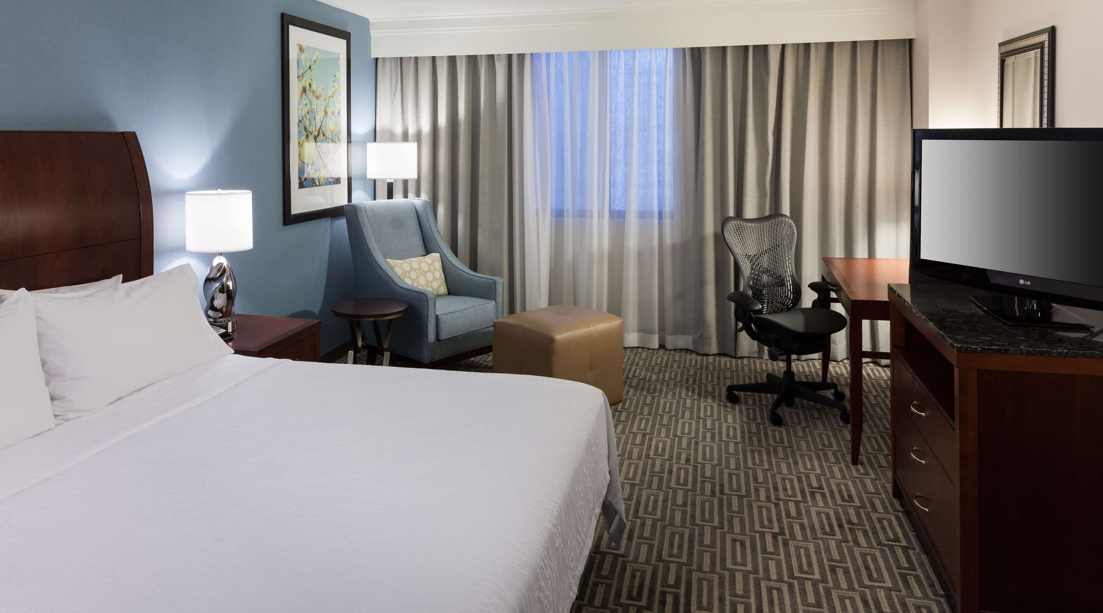 Premium bedding, desk, laptop workspace, iron/ironing board