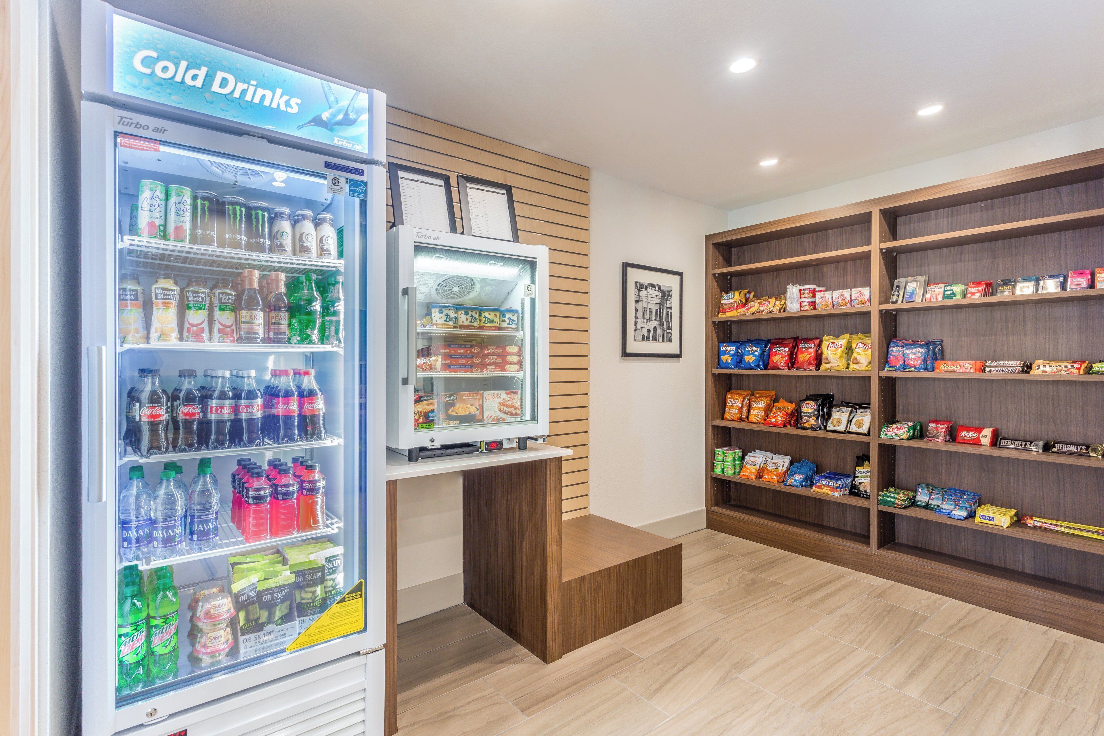 A snack and cold drink vending area with various brands of snacks and beverages.