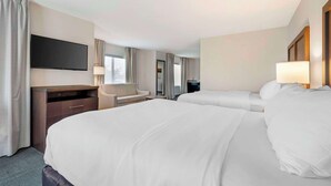 A hotel room with two beds, a desk, a TV, and a window with curtains. - Comfort Inn & Suites Chestertown (Chestertown)