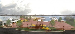 A waterfront property with a marina, a large parking lot, and several buildings with a modern architectural style.