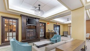 A modern lounge area with seating, a fireplace, and a television. - Comfort Inn & Suites Chestertown (Chestertown)