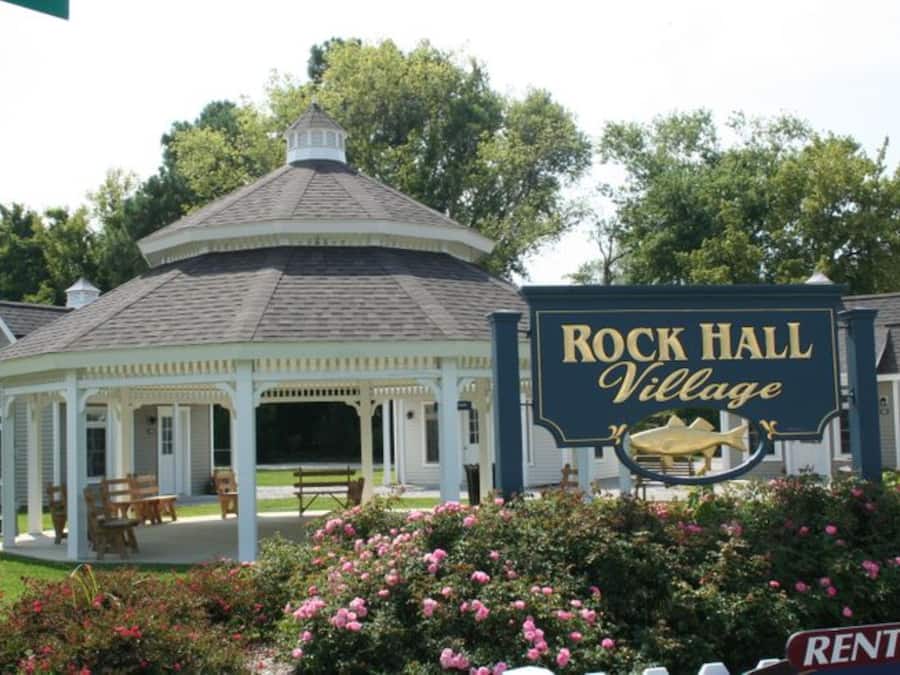 A gazebo with a sign reading "Rock Hall Village" and a fish symbol.
