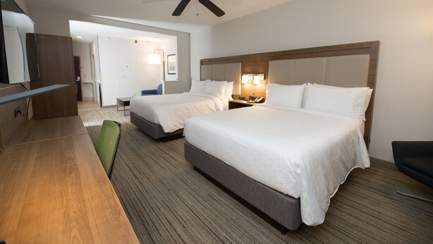 A hotel room with two beds, a desk, a chair, a ceiling fan, and a TV. - Holiday Inn Express Clinton by IHG (Clinton)