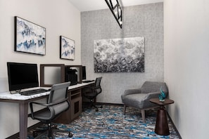 Work in comfort with a desk area, computer setup, and two chairs.