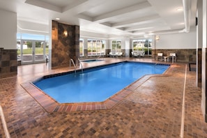 An indoor swimming pool with a tiled floor and a clear blue pool. - Holiday Inn Laramie by IHG (Laramie)