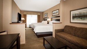 A hotel room with two beds, a sofa, a TV, and a desk. - Holiday Inn Laramie by IHG (Laramie)