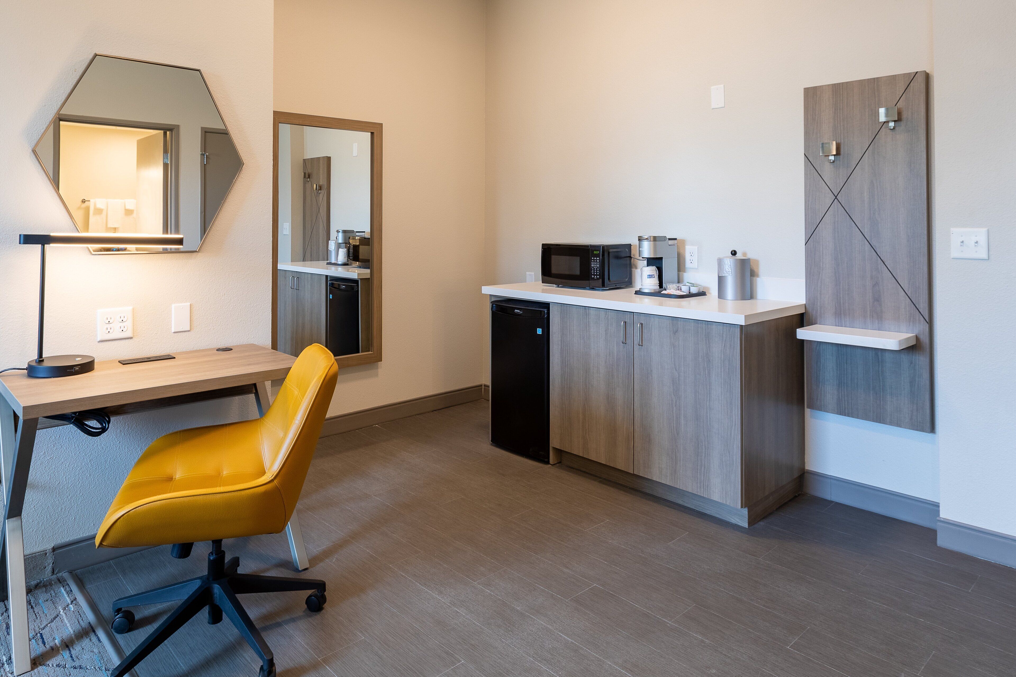 A modern kitchen with a microwave, coffee maker, and a dishwasher.