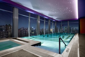 A rooftop infinity pool with city views, large windows, and a starry ceiling. - Renaissance Shanghai Yu Garden Hotel on the Bund by Nanjing Road (Shanghai)