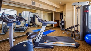 A gym with treadmills, elliptical machines, and weightlifting equipment. - Best Western Windsor Pointe Hotel & Suites-Frost Bank Center (San Antonio)