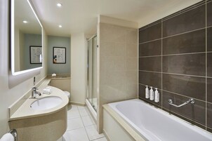 A modern bathroom with a bathtub, a sink, and a shower.