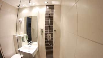 A modern bathroom with a glass shower enclosure, a white sink, and a toilet.