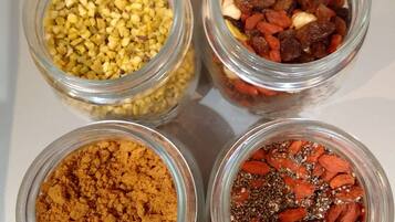 Four glass jars containing different food items.