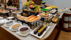 A buffet with various food items and a chef in the background. - Amaya Hills Kandy (Kandy)