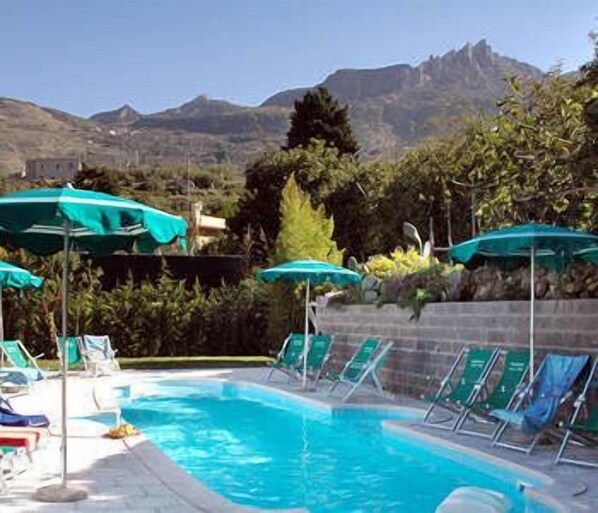 Seasonal outdoor pool, open 9 AM to 7 PM, pool umbrellas, pool loungers