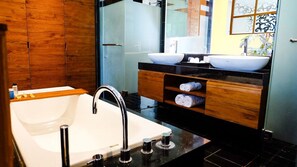 Een aparte badkuip en douche, gratis toiletartikelen, een haardroger