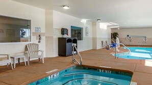 A pool area with clear water, lounge chairs, and a lifeguard stand. - Comfort Inn & Suites Lordsburg I-10 (Lordsburg)
