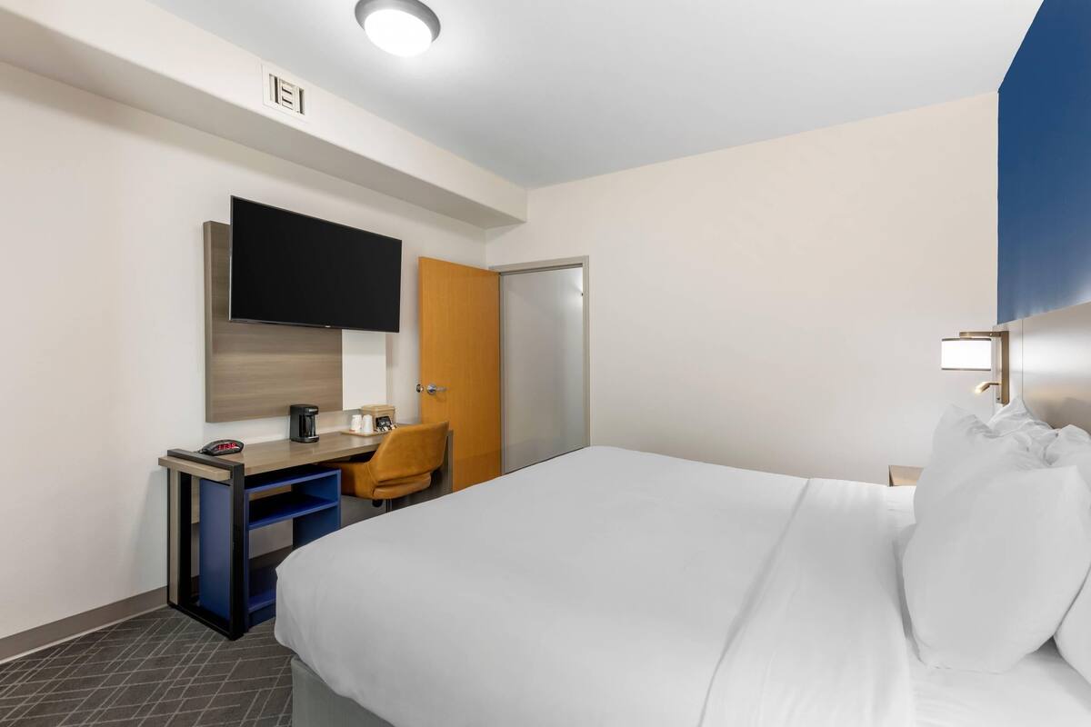 Premium bedding, desk, laptop workspace, blackout drapes