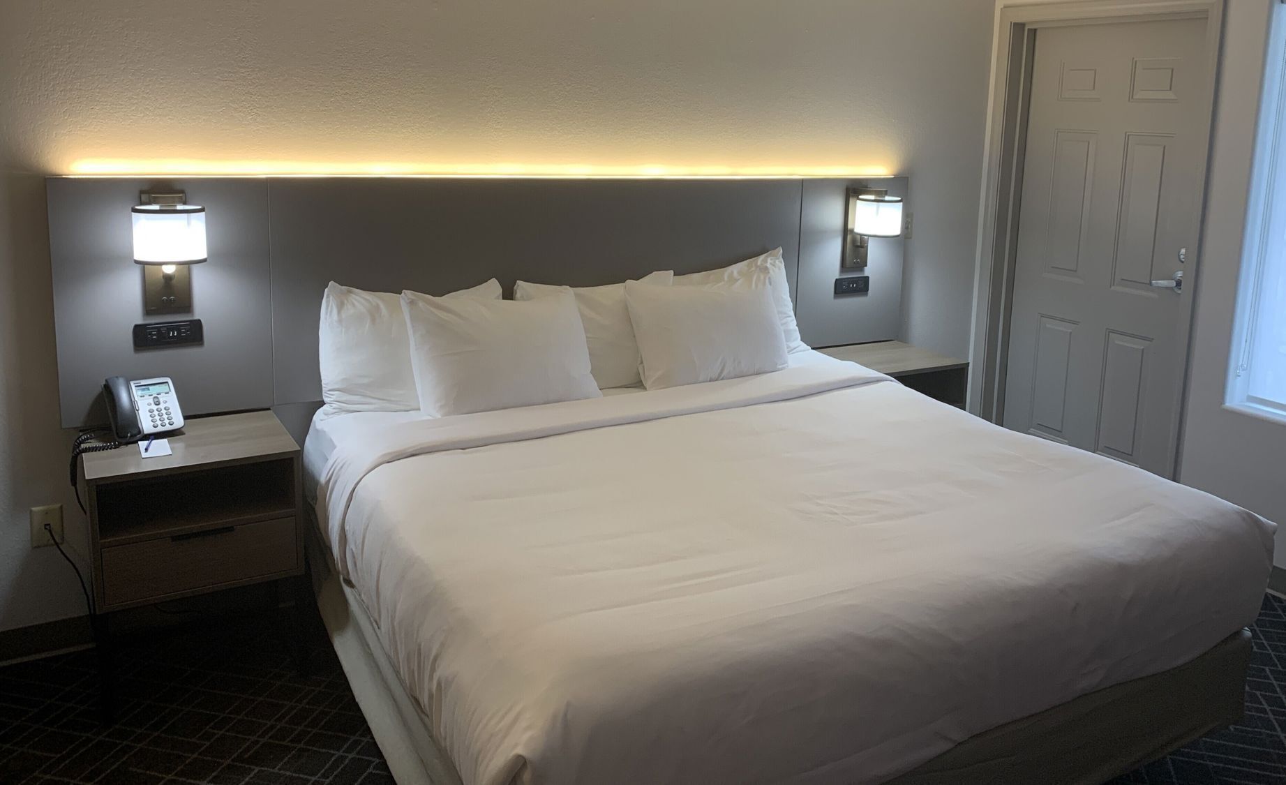 Premium bedding, desk, laptop workspace, blackout curtains