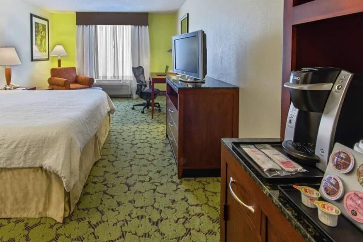 Premium bedding, desk, laptop workspace, blackout drapes