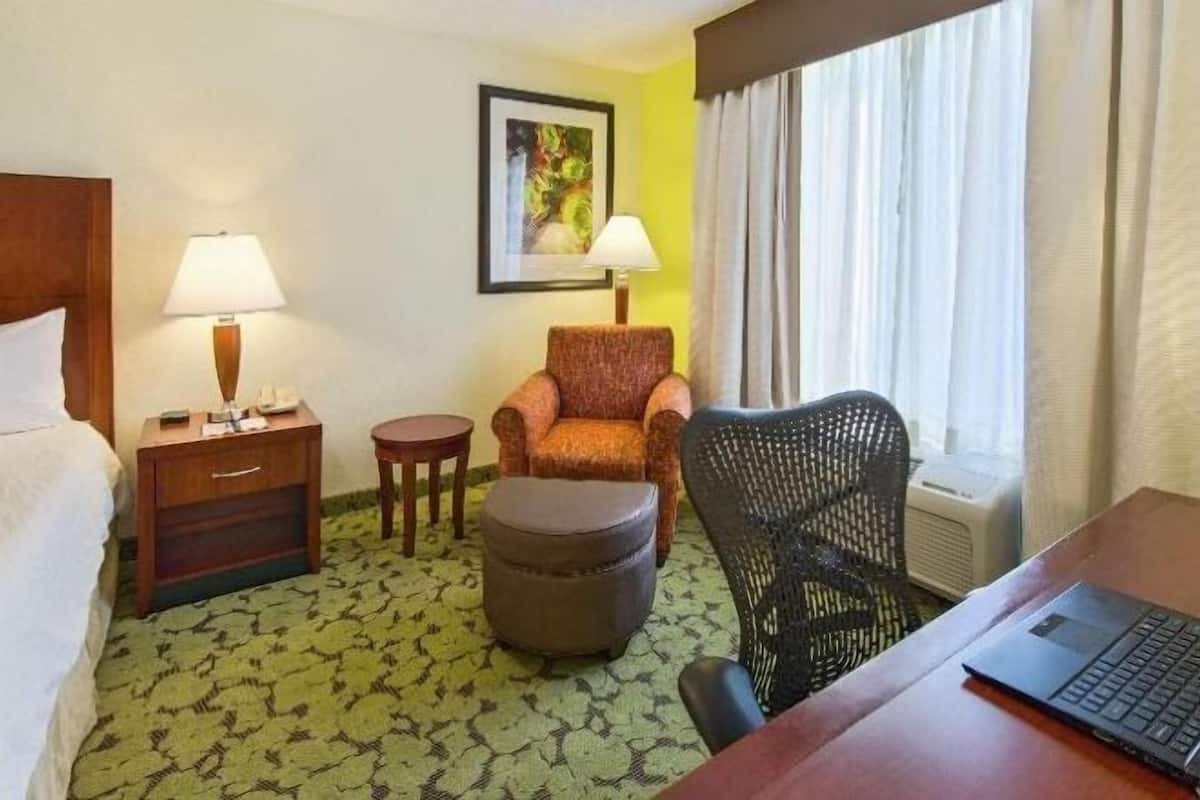 Premium bedding, desk, laptop workspace, blackout drapes