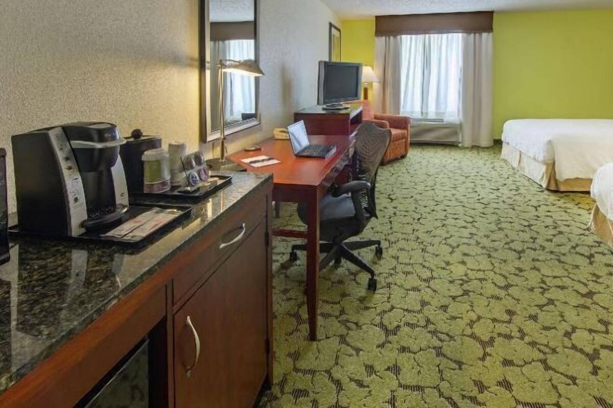 Premium bedding, desk, laptop workspace, blackout drapes