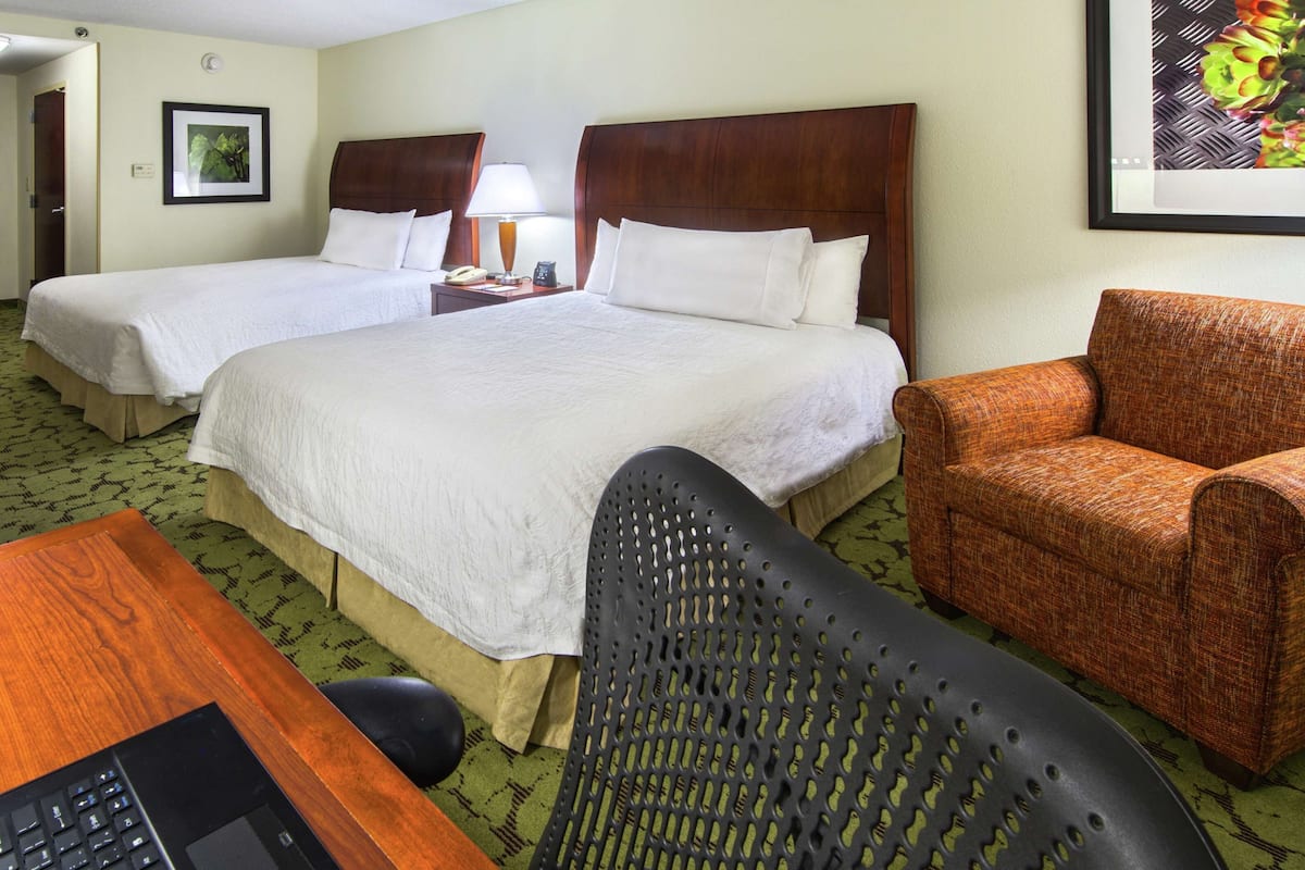 Premium bedding, desk, laptop workspace, blackout drapes