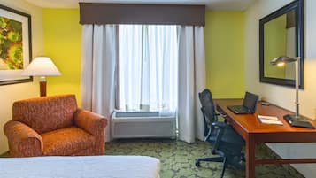 Premium bedding, desk, laptop workspace, blackout drapes