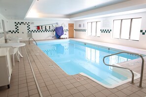 A swimming pool with a tiled deck, a lifeguard chair, and a pool lift. - Holiday Inn Express Hotel & Suites Logansport by IHG (Logansport)