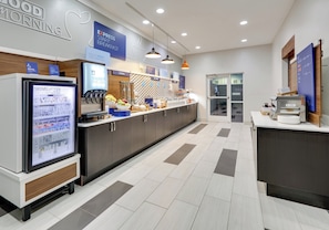 A modern breakfast area with a refrigerator, coffee machine, and various food options. - Holiday Inn Express Hotel & Suites Cleburne by IHG (Cleburne)