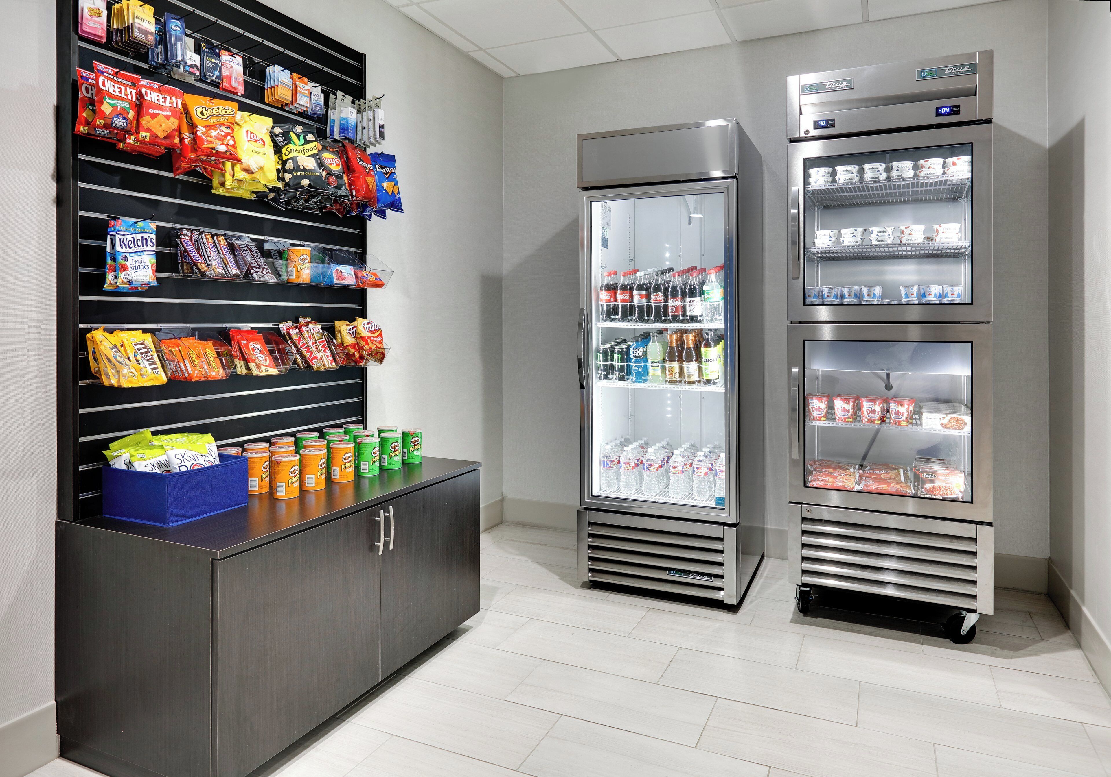 A vending machine stocked with snacks and beverages, including chips, sodas, and bottled water.